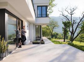 couple enjoying on the door of their luxury home villa photo