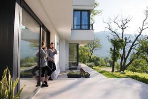 couple enjoying on the door of their luxury home villa photo