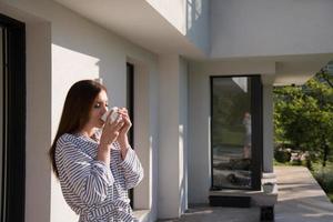 woman in a bathrobe enjoying morning coffee photo