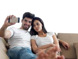 young couple making selfie together at home photo