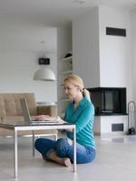 young women using laptop computer on the floor photo