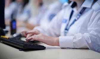 Female security guards working in a security data system control room photo