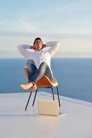 relaxed young man at home on balcony photo