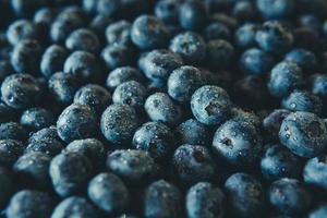 Freshly picked juicy blueberries background, flat lay. Blueberries texture photo