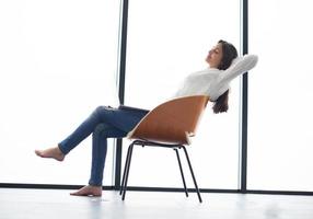 relaxed young woman at home working on laptop computer photo