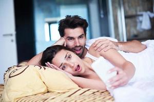 couple relax and have fun in bed photo