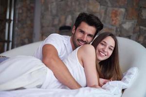 couple relax and have fun in bed photo