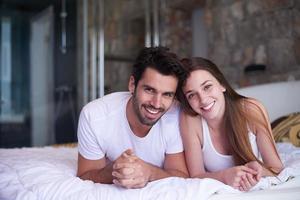 couple relax and have fun in bed photo