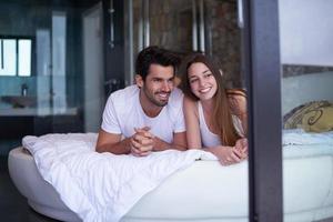 couple relax and have fun in bed photo