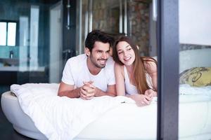 couple relax and have fun in bed photo