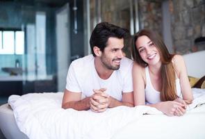 couple relax and have fun in bed photo