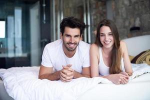 couple relax and have fun in bed photo