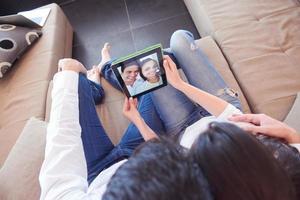 couple at modern home using tablet computer photo