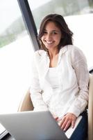 relaxed young woman at home working on laptop computer photo