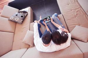 couple at modern home using tablet computer photo