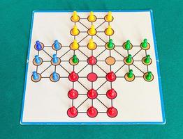 gameplay of solitaire board game on green table photo