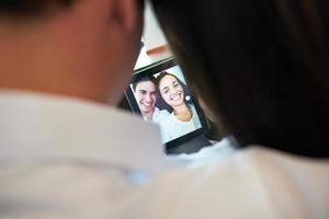 couple at modern home using tablet computer photo