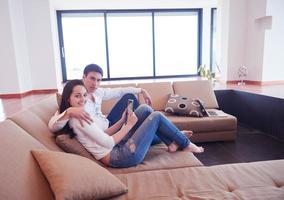 couple at modern home using tablet computer photo