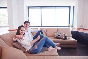 couple at modern home using tablet computer photo