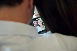 couple at modern home using tablet computer photo