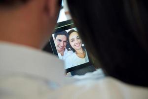 couple at modern home using tablet computer photo