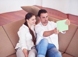 couple at modern home using tablet computer photo