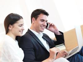 relaxed young couple working on laptop computer at home photo