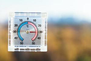 view of outdoor thermometer in hot autumn day photo