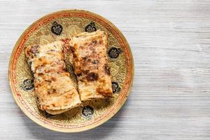 Butter Naan on brass plate on gray wooden table photo