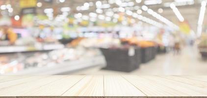 Wood table top with supermarket grocery store blurred defocused background with bokeh light photo