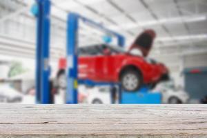 Wood table top with blur car service centre background photo