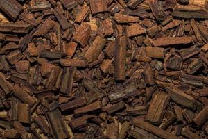 Background of crushed cinnamon sticks for making a tea mixture. Cinnamon texture. photo