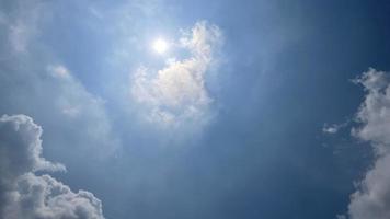 Heavenly white clouds on the blue sky with the sun appeared photo