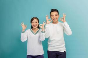 Happy Asian couple love excited smiling with ok hand gesture photo