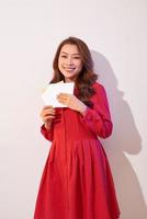 Happy female enjoying greeting card, reading with pleasure love letter, celebrate Valentine day at home photo