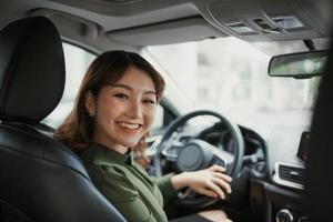 Pretty young woman driving car photo