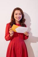 Young beautiful woman looking Invitation card and smile photo