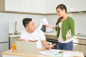 Woman and man arguing about money at home. Problems in relationship photo