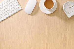 Modern white office desk with keyboard, mouse, oclock and cup of coffee.Top view with copy paste. Business and strategy concept mockup. photo