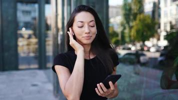 Woman on the street using smartphone video