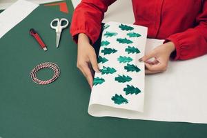 Female hands making a box rabbit. Holiday Easter light. Material for creative. photo