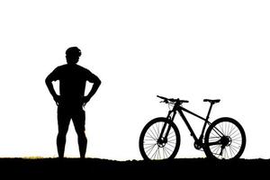 silhouette of a person riding a bike photo