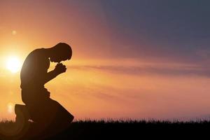 Silhouette of Christian Praying Hands Spiritual and Religious People Praying to God Christianity Concepts photo