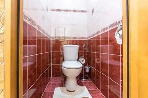 white ceramic toilet bowl in restroom photo