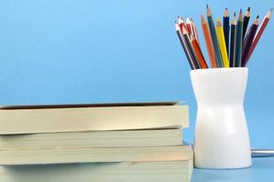 moderno de conceptos de regreso a la escuela con libros, bolígrafos, lápices aislados sobre fondo azul claro. utilizado en el cartel de regreso a la escuela, folleto foto