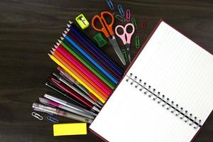 Pile of books with color pencils and education elements, back to school concept photo