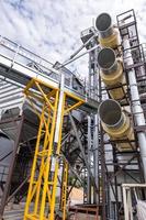 Modern Granary elevator. Silver silos on agro-processing and manufacturing plant for processing drying cleaning and storage of agricultural products, flour, cereals and grain. photo