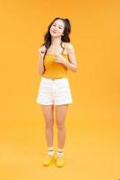 happy young woman or teen girl touching long wavy hair photo