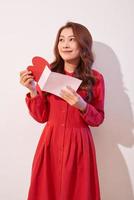 Happy female enjoying greeting card, reading with pleasure love letter, celebrate Valentine day at home photo