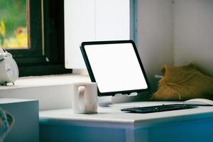 tablet for work on wood desk, a blank tablet screen can add text or other media. photo